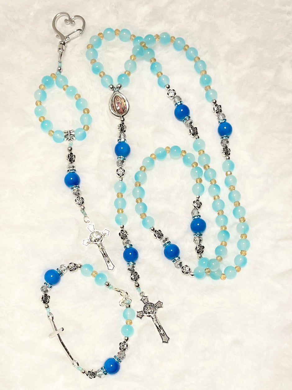 Handcrafted 3-piece Catholic gift set in aqua & cobalt blue glass. Includes a traditional 5-decade rosary, a heart clasp keychain, and a stretch faith bracelet.