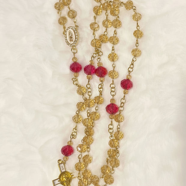 Handcrafted 5-decade champagne glass rosary with red beads, a white enamel Virgin de Guadalupe center, and a matching gold St. Benedict crucifix.