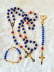Handcrafted 3-piece Catholic gift set featuring a full 5-decade cobalt glass rosary, a matching gold heart clasp keychain, and a coordinated gold cross bracelet.
