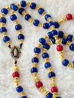 A full-length prayer loop detailed with a premium rhinestone-ringed Our Lady of Guadalupe centerpiece medal and a magnificent gold sunburst crucifix with rich blue and red enamel inlay.