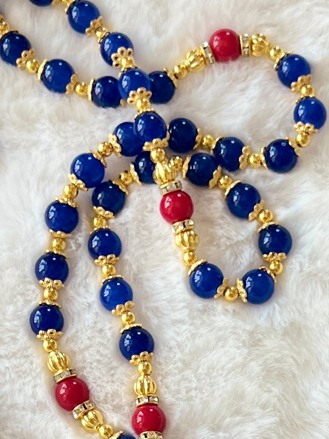 A full-length prayer loop detailed with a premium rhinestone-ringed Our Lady of Guadalupe centerpiece medal and a magnificent gold sunburst crucifix with rich blue and red enamel inlay.