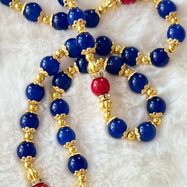 A full-length prayer loop detailed with a premium rhinestone-ringed Our Lady of Guadalupe centerpiece medal and a magnificent gold sunburst crucifix with rich blue and red enamel inlay.