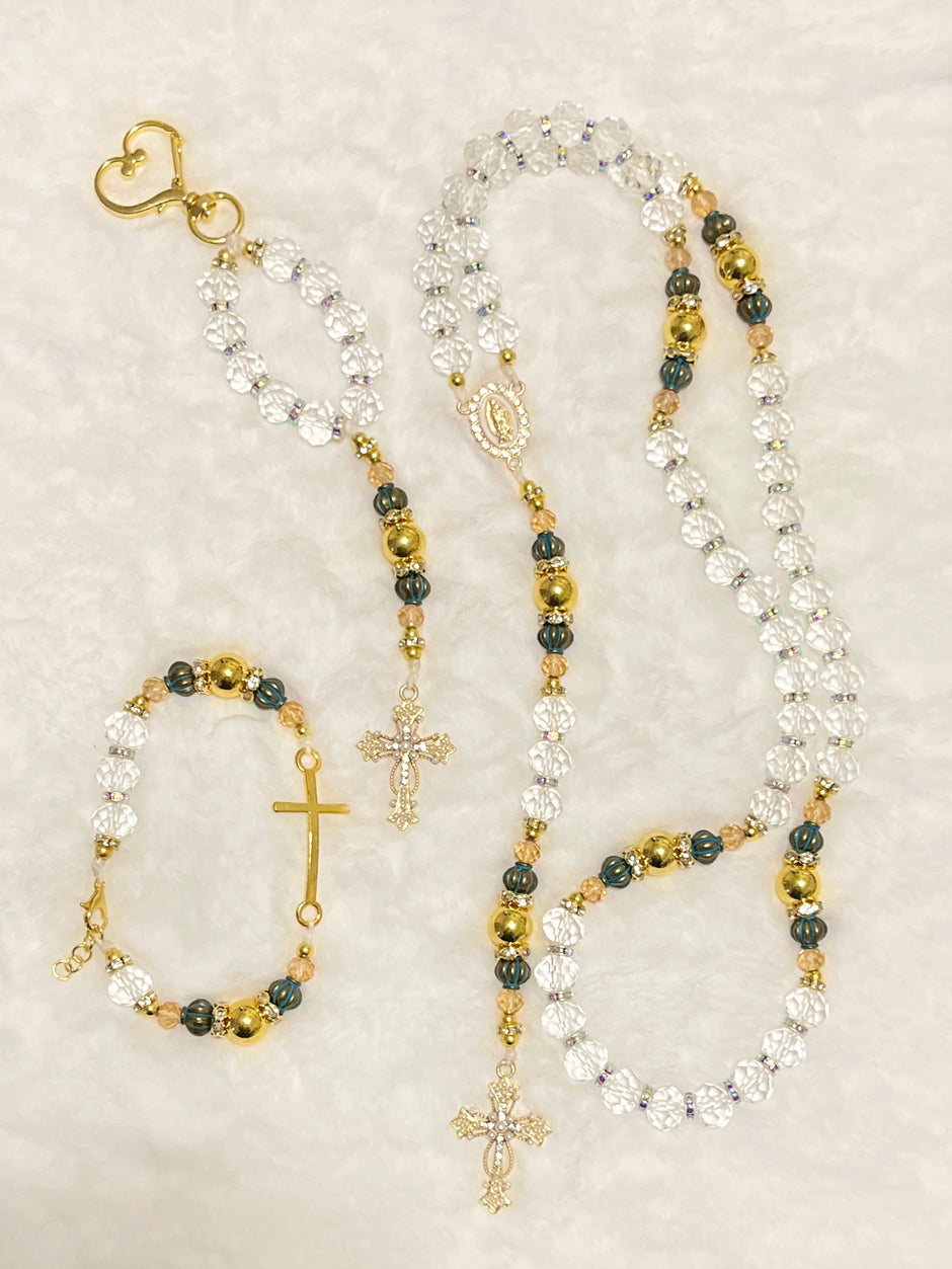 Handcrafted 3-piece Catholic gift set featuring a full 5-decade clear crystal rosary, a matching gold heart clasp keychain, and a coordinated gold cross bracelet.