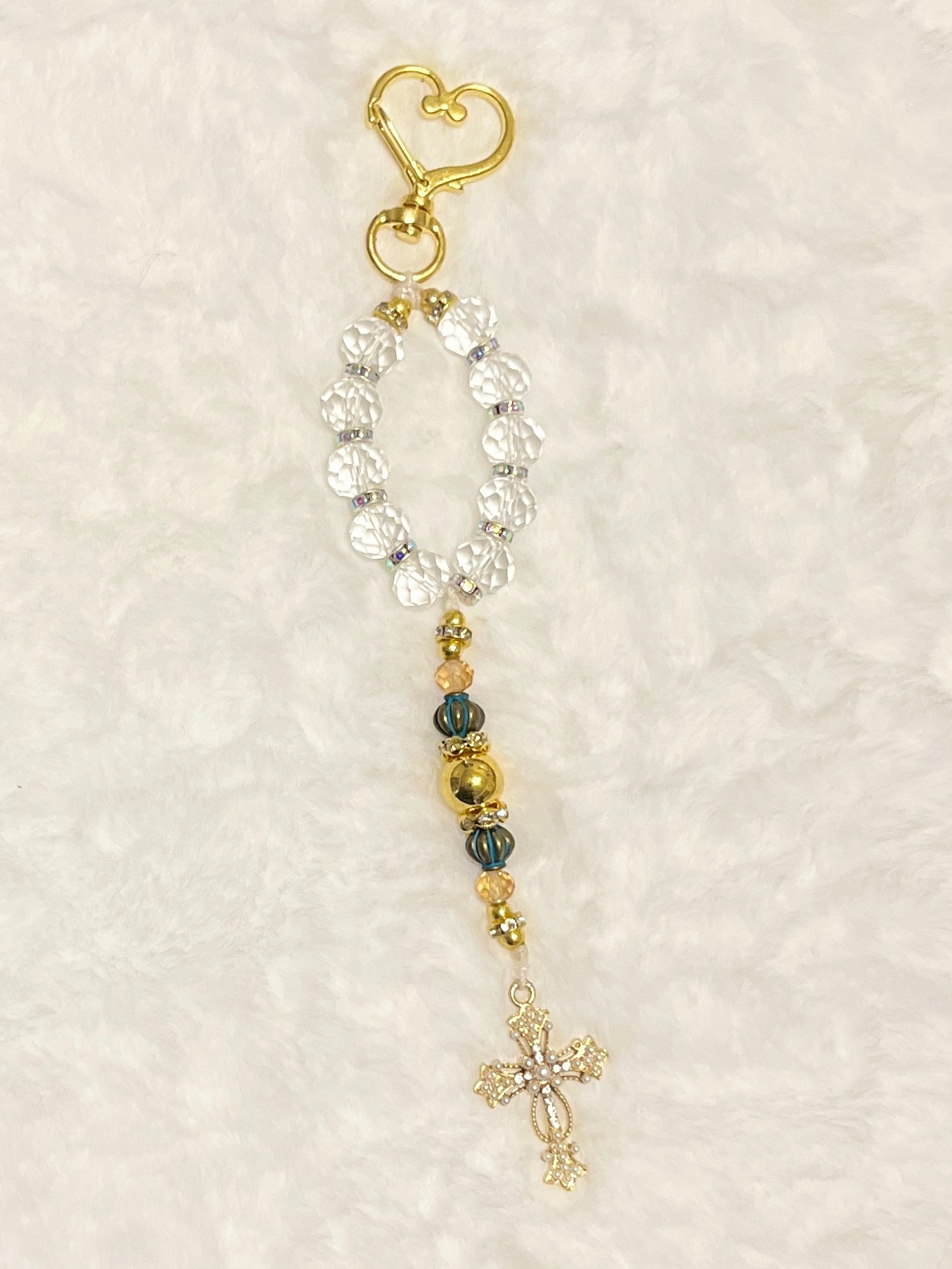 A compact accent loop equipped with a premium, large gold heart-shaped lobster clasp keychain closure and matching cross—perfect for securely adding to your car keys, purse strap, or travel bag.