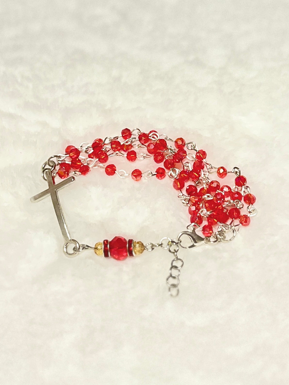Handcrafted multi-wrap full 5-decade rosary bracelet featuring 50 faceted ruby red glass crystals, a rhinestone Our Father bead, and a curved silver cross.