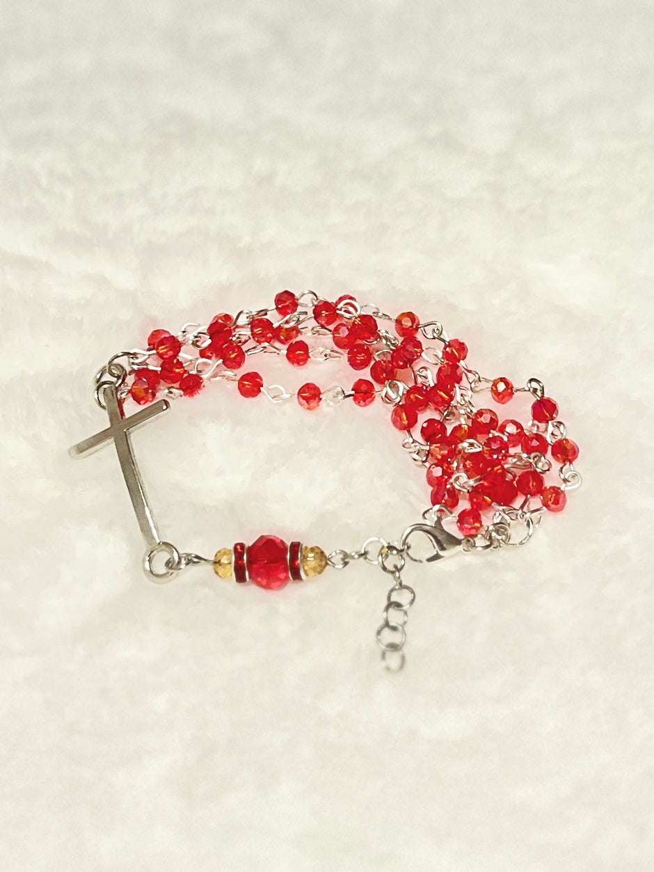Handcrafted multi-wrap full 5-decade rosary bracelet featuring 50 faceted ruby red glass crystals, a rhinestone Our Father bead, and a curved silver cross.
