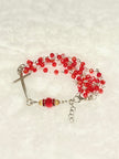 Handcrafted multi-wrap full 5-decade rosary bracelet featuring 50 faceted ruby red glass crystals, a rhinestone Our Father bead, and a curved silver cross.