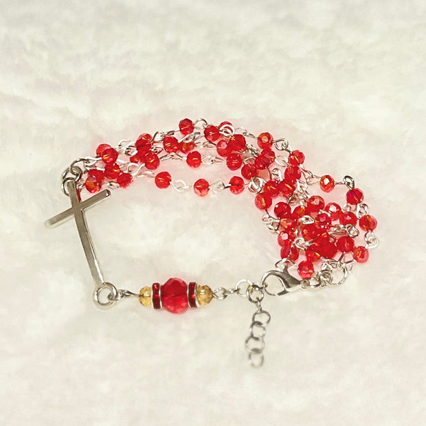 Handcrafted multi-wrap full 5-decade rosary bracelet featuring 50 faceted ruby red glass crystals, a rhinestone Our Father bead, and a curved silver cross.