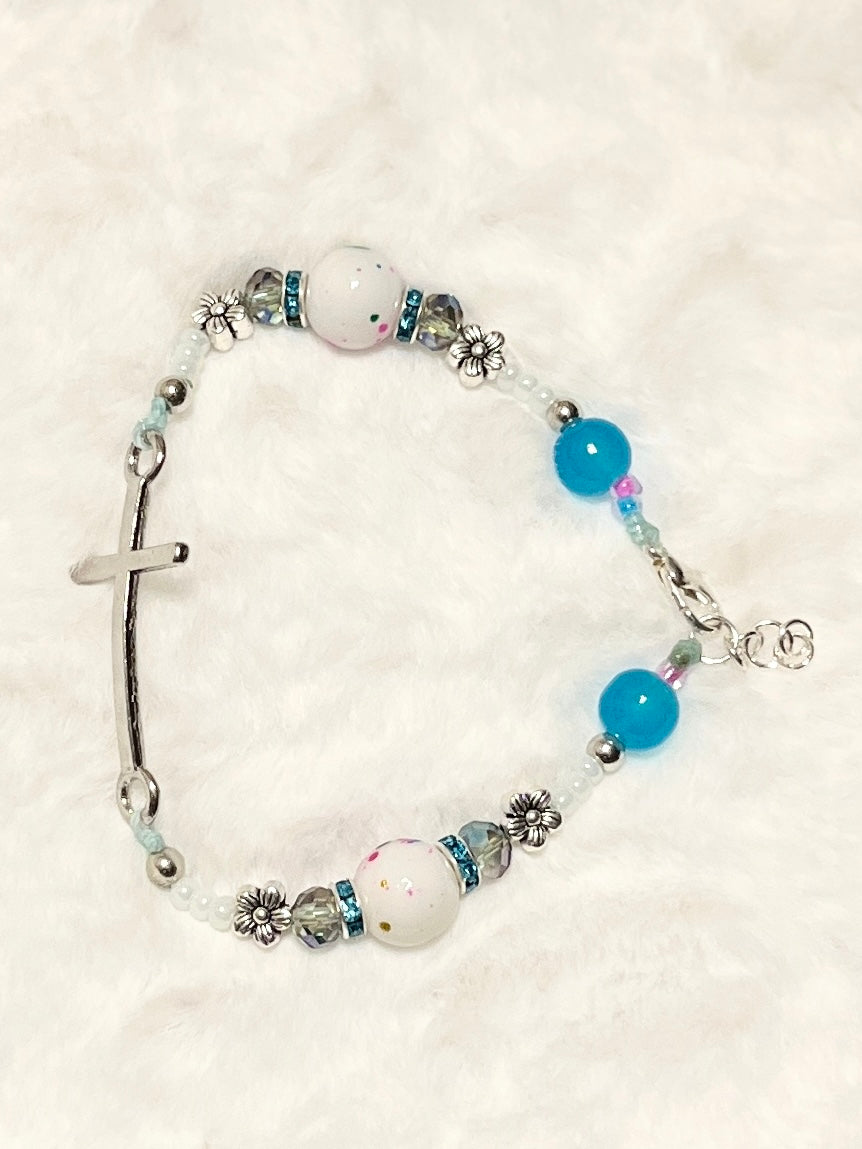 A beautiful wearable statement of faith featuring a sleek curved silver cross bar, a secure lobster clasp closure, and an adjustable sizing extension chain.