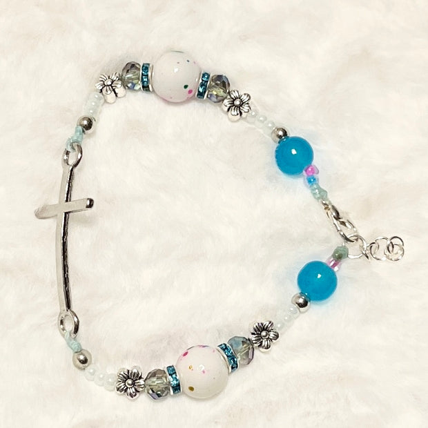 A beautiful wearable statement of faith featuring a sleek curved silver cross bar, a secure lobster clasp closure, and an adjustable sizing extension chain.